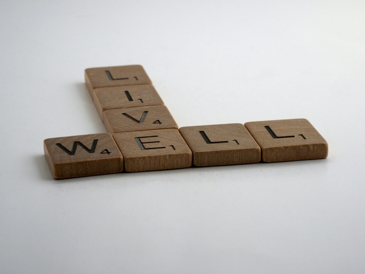 Wooden tiles spelling Live Well, Wellness